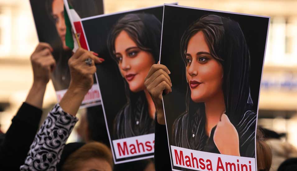 Protestierende halten Bilder der verstorbenen Mahsa Amini hoch.