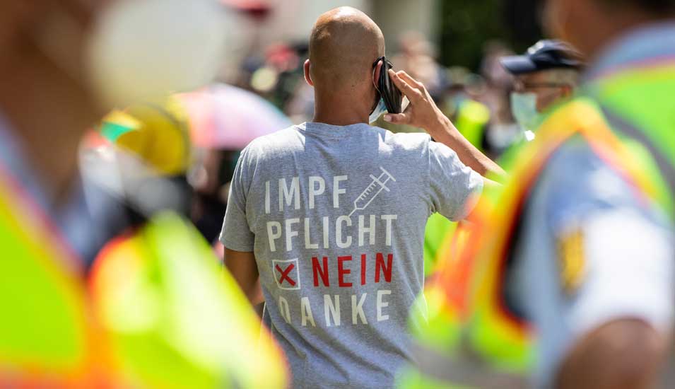 Mann auf einer "Querdenker"-Demonstration, die Aufschrift auf seinem T-Shirt lautet "Impfpflicht nein danke".